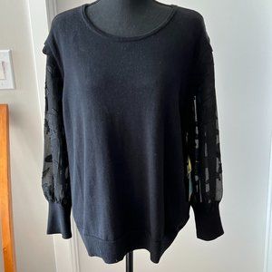 Rich Black CeCe sweater with sheer floral sleeves